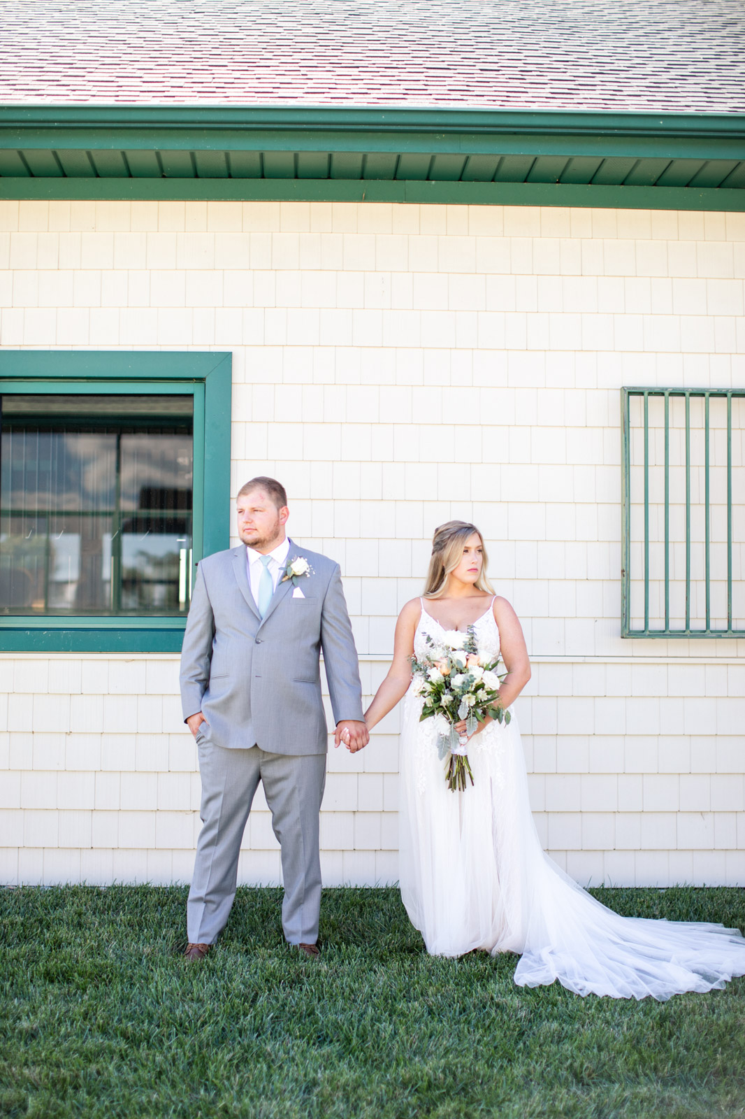 Bride and groom in front of barn at Vignon Manor Farm