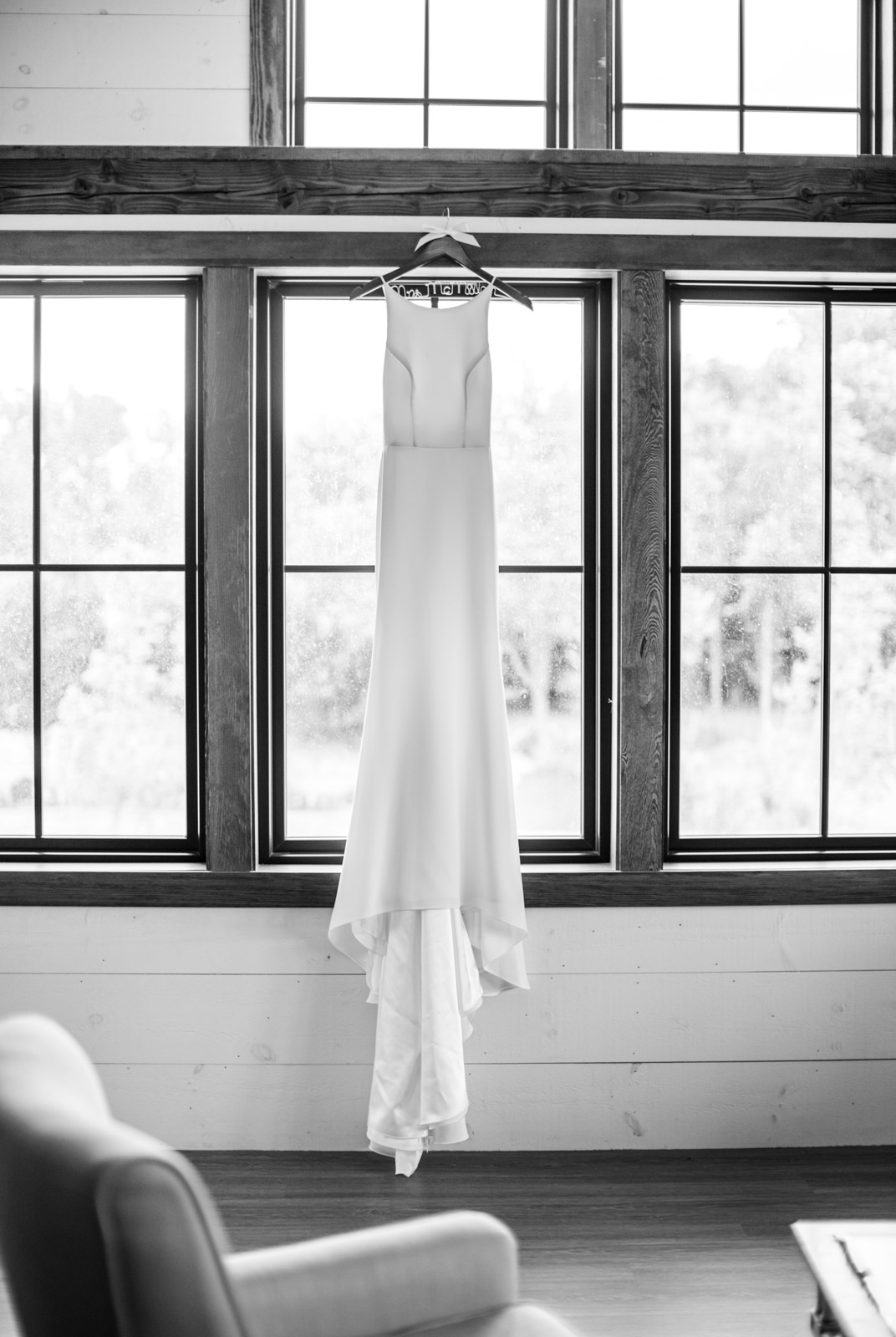 Wedding Dress hanging in window at Kent Island Resort in black and white