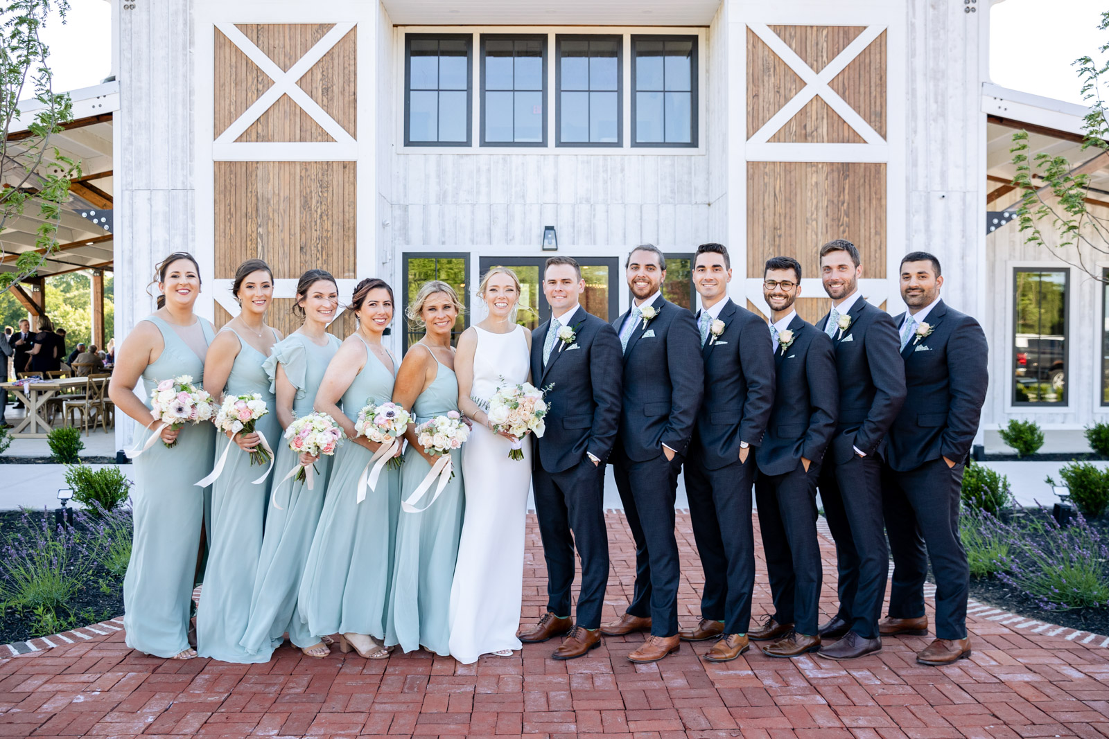 Bridal party posing for portrait outside of Kent Island Resort reception space