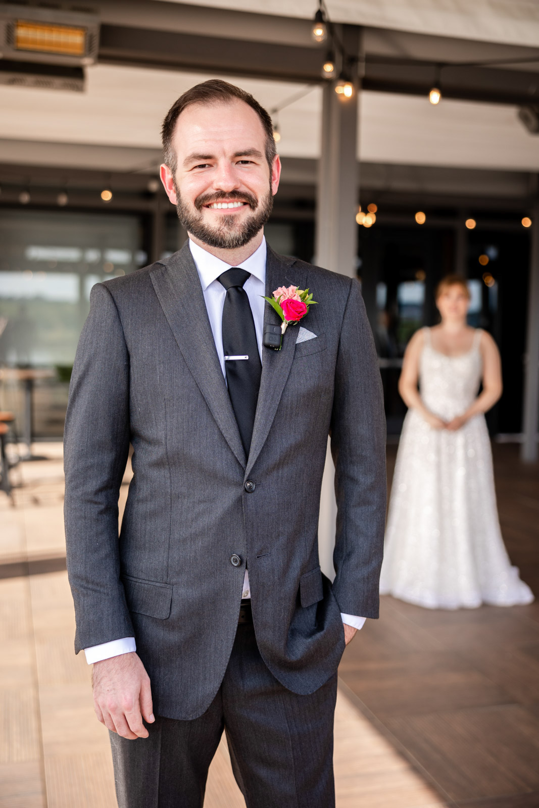 Groom smiling for camera while waiting for first look at District Winery Wedding