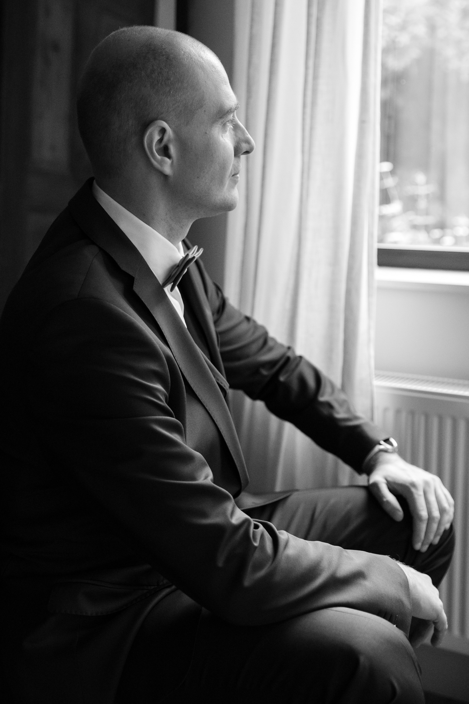 Black and white groom portrait before a wedding ceremony in Belgium 