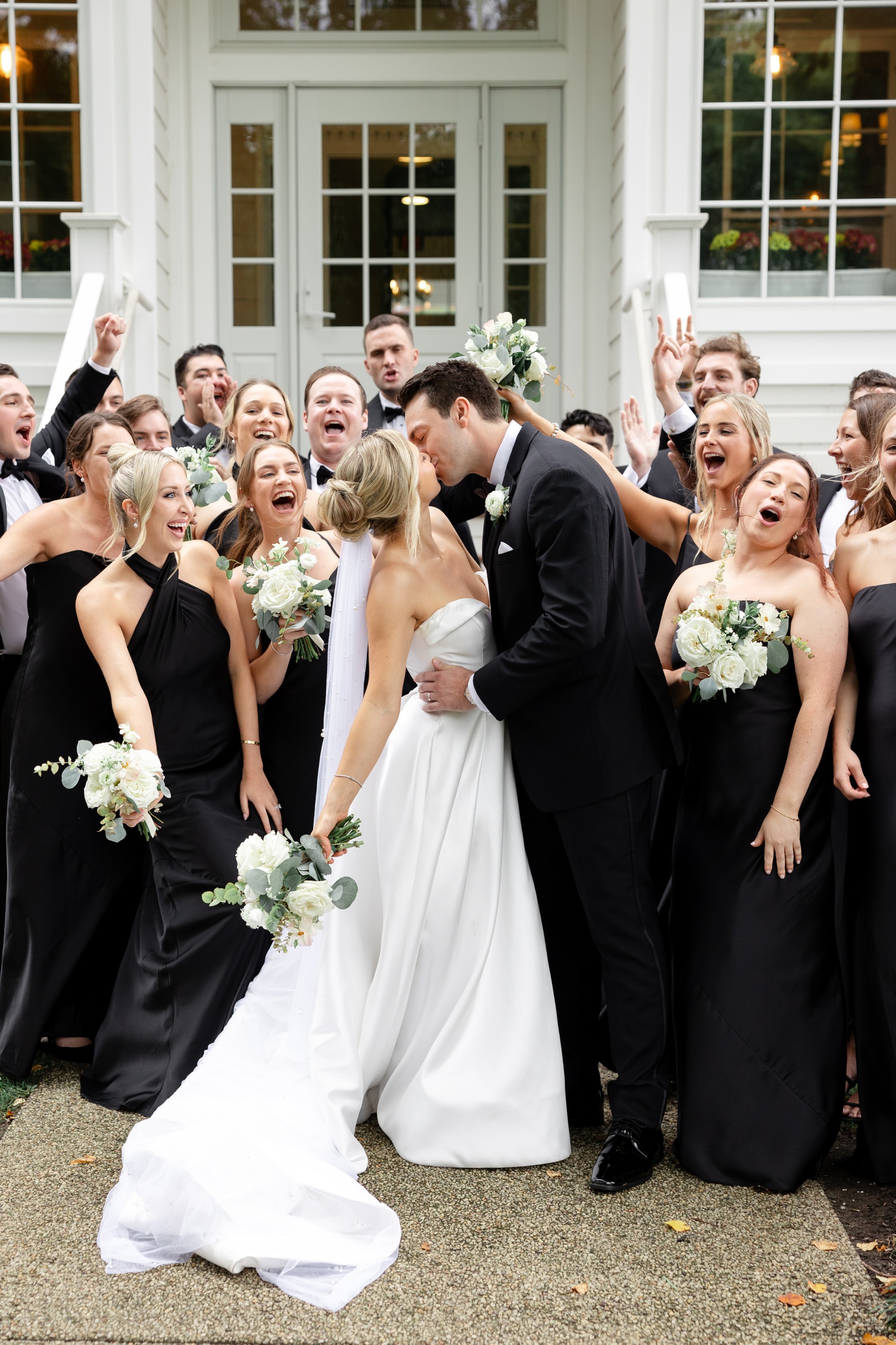 Bridal party in black dresses with all white flower bouquets for a Maryland wedding