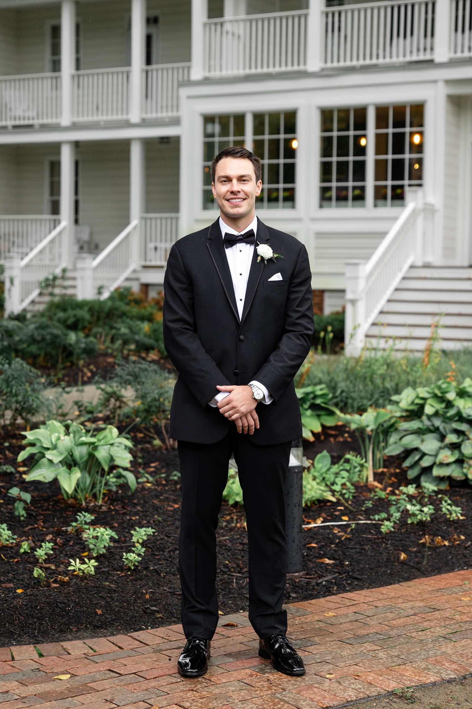 Groom in a classic black tuxedo for his wedding at Kent Island Resort