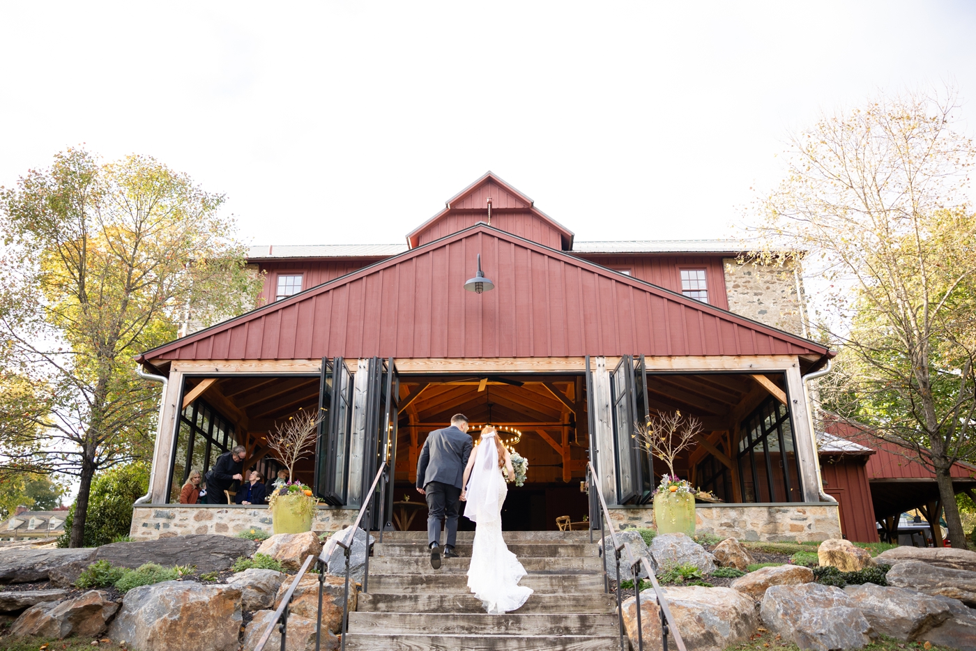 Bride and groom walking up the steps at The Inn at Grace Winery after their wedding ceremony