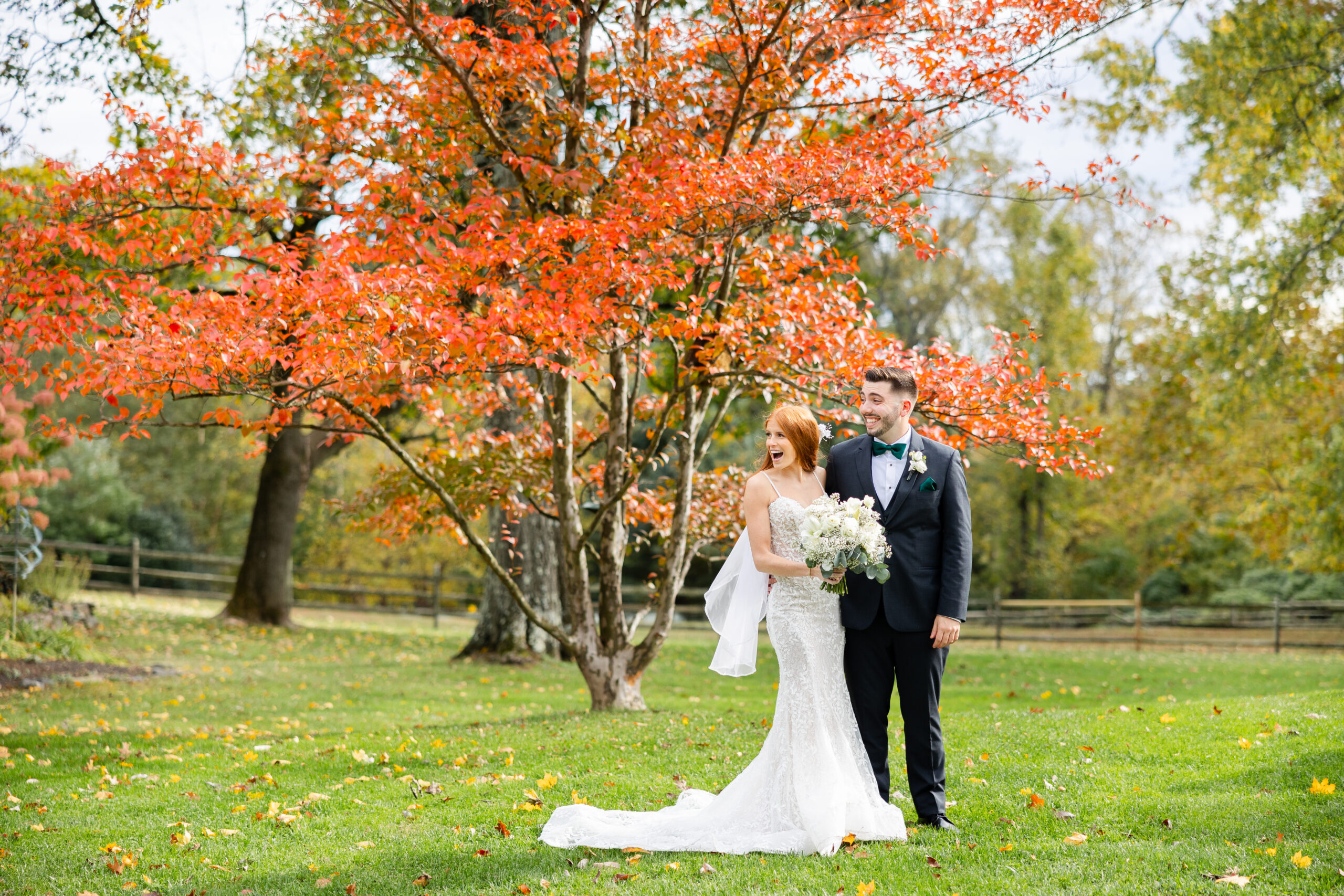 Bride laughing after a ladybug landed on her wedding dress during the bride and groom portraits