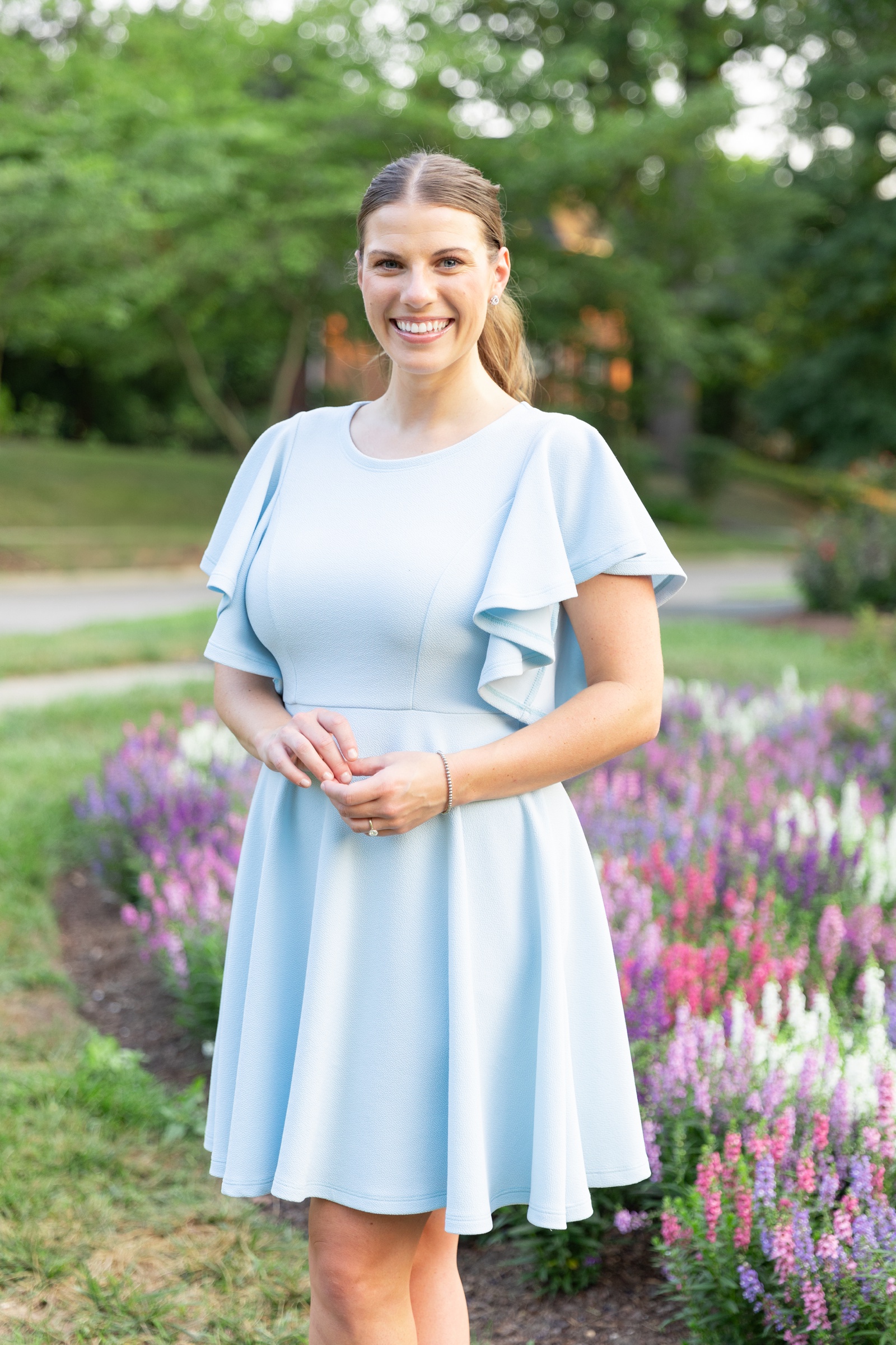 Bride in a blue flutter-sleeve mini dress for her engagement session