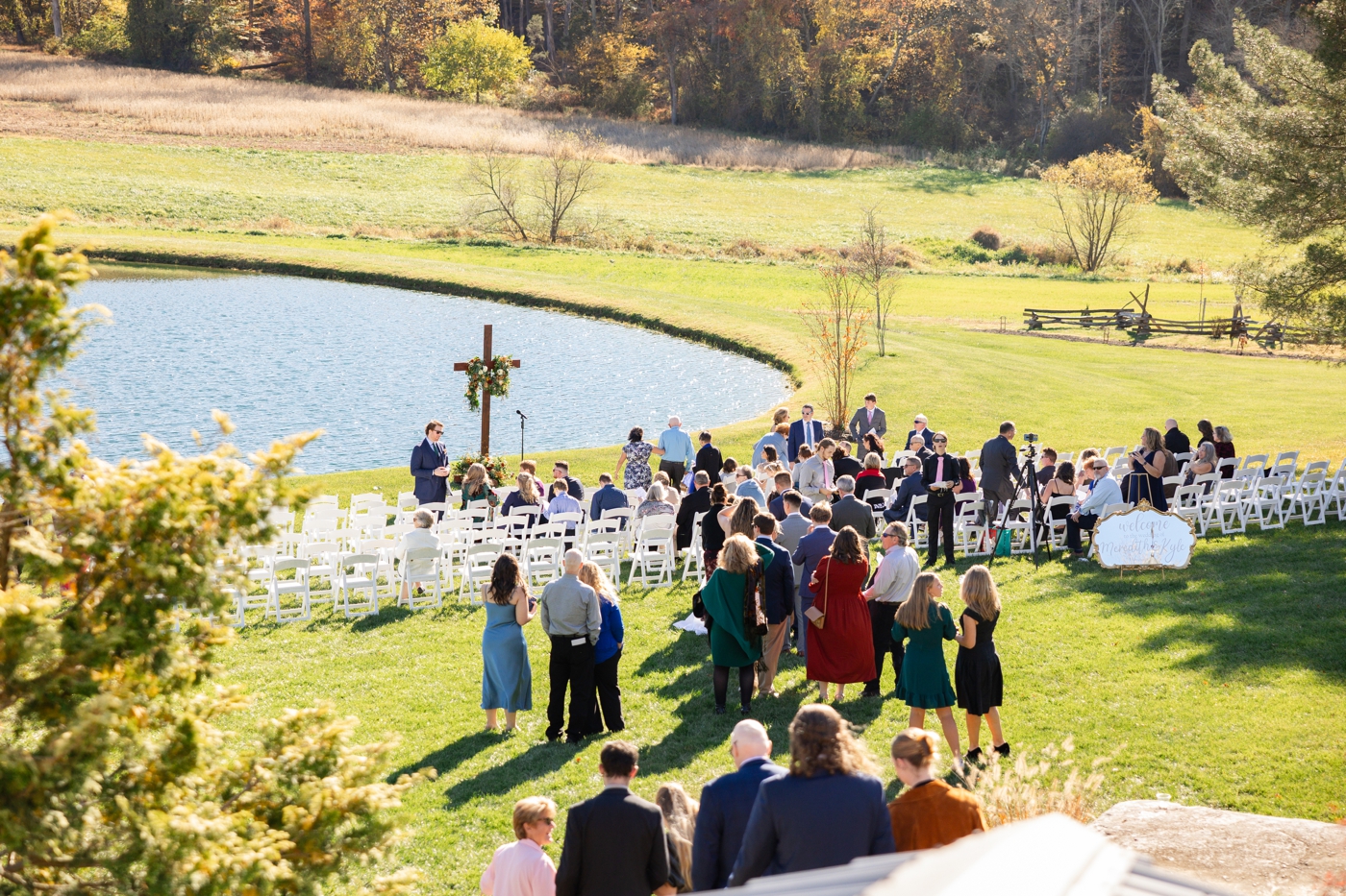 Outdoor wedding ceremony on the lawn of Stone Ridge Hollow, overlooking the pond