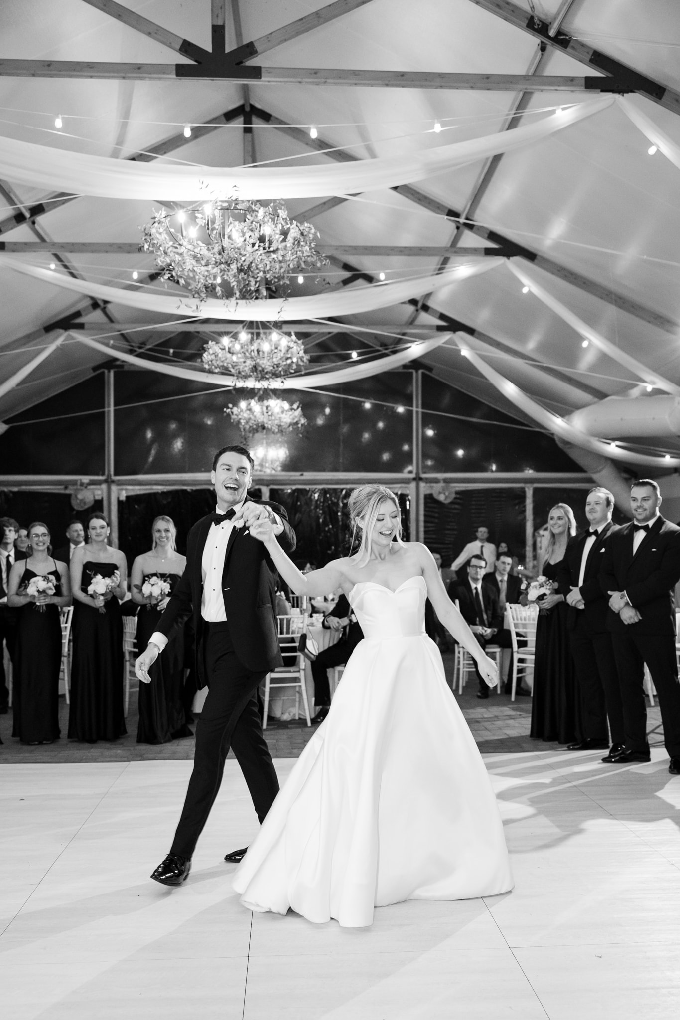 Black tie wedding reception under chandeliers in the Kent Island Pavilion