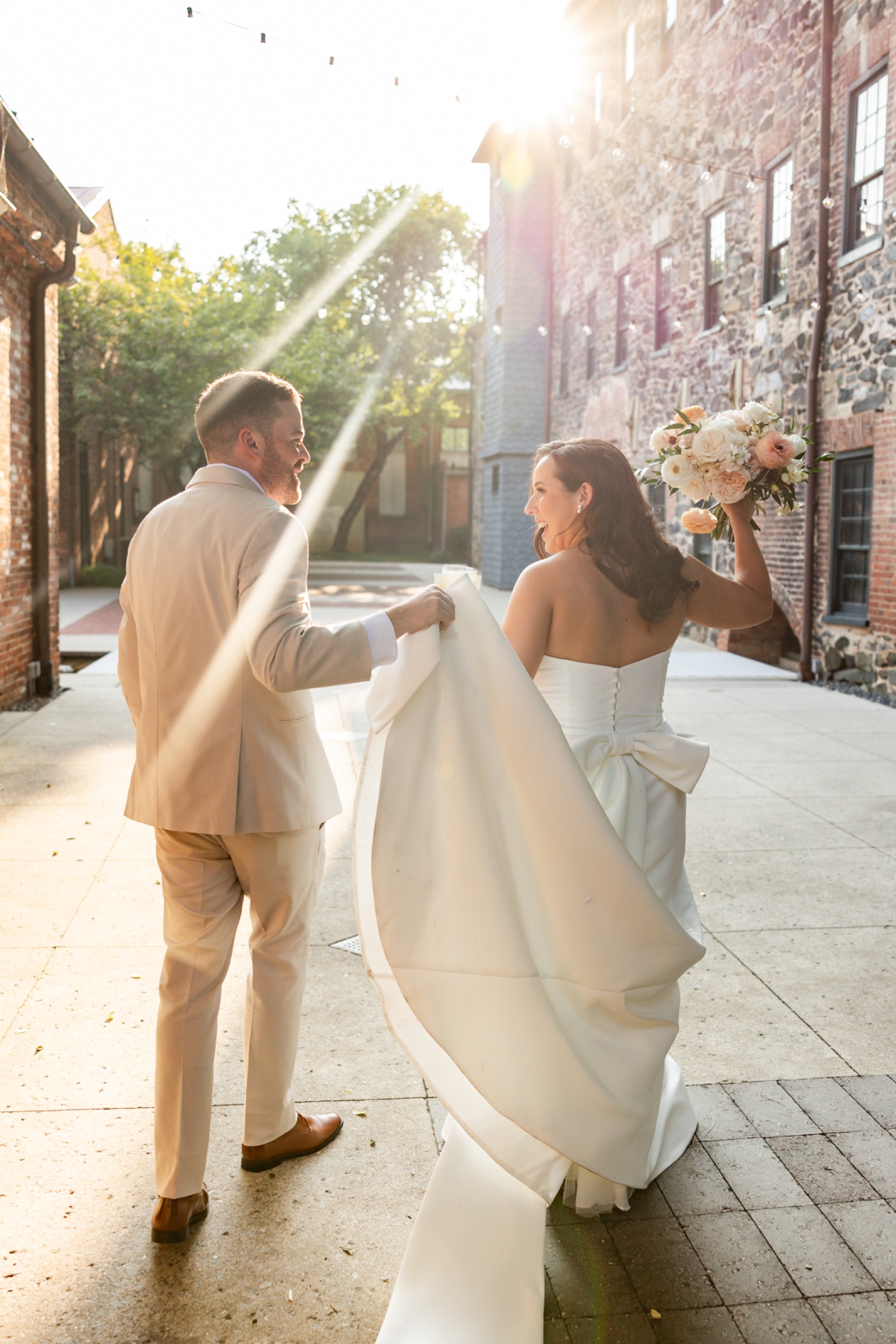 Bride and groom portraits in the courtyard at Mt Washington Mill Dye House in Baltimore