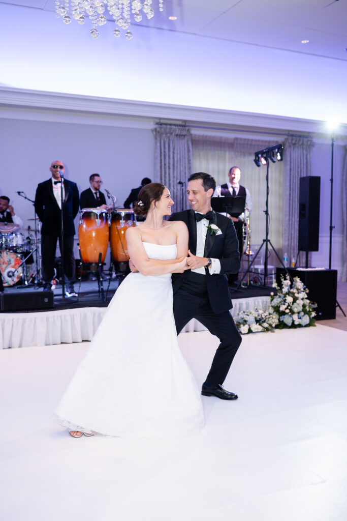 Bride and groom sharing their first dance in the ballroom at Woodmont Country Club wedding.