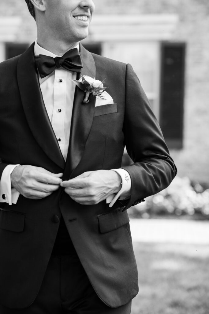 Groom in black tie attire before the ceremony at Woodmont Country Club wedding.