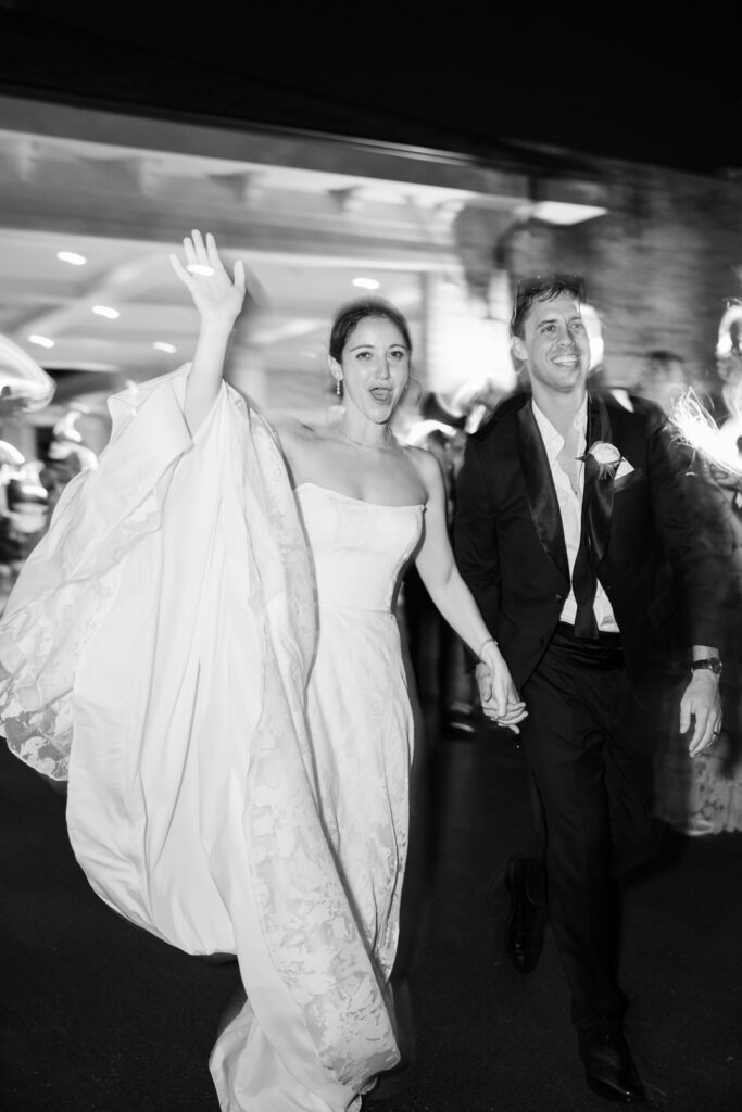 Bride and groom exiting under sparklers at the end of their Woodmont Country Club wedding.