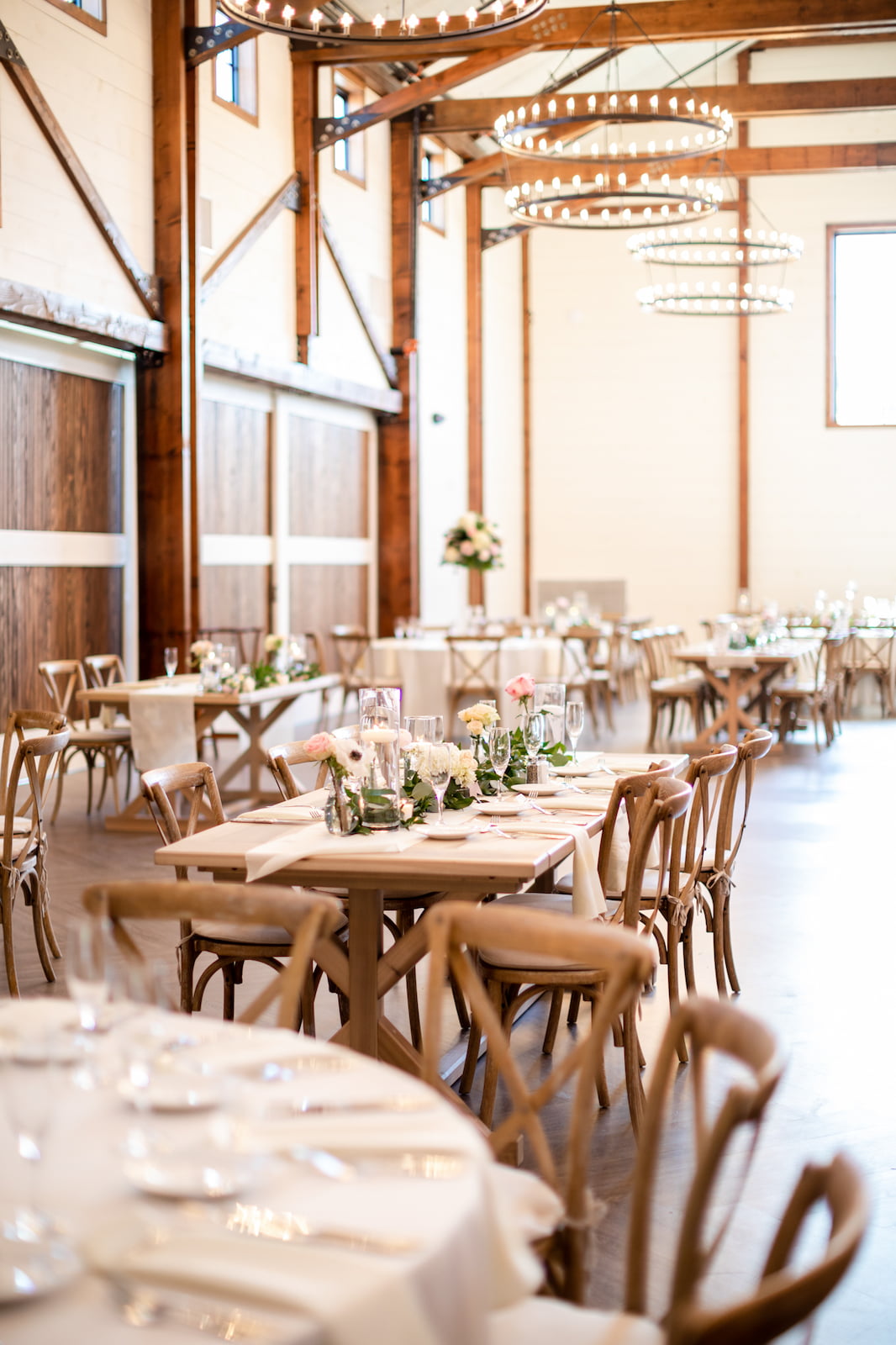 Farmstead reception design with candlelight and ring chandeliers