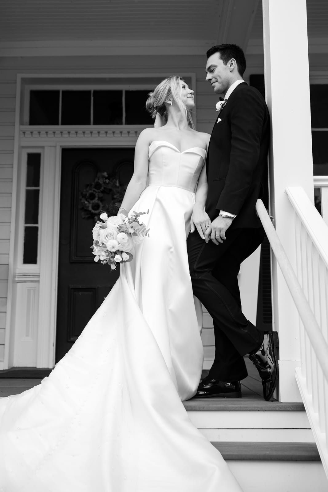 Bride and Groom wedding portrait on the front steps of the Manor House at Kent Island Resort